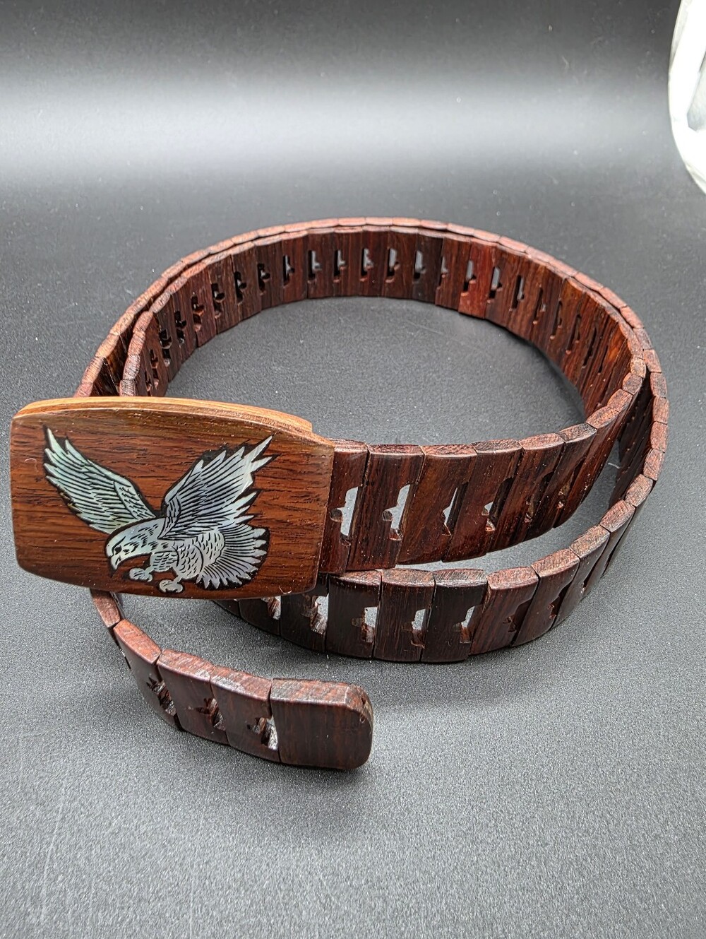 Vintage Wooden link belt features a carved wooden buckle adorned with abalone
